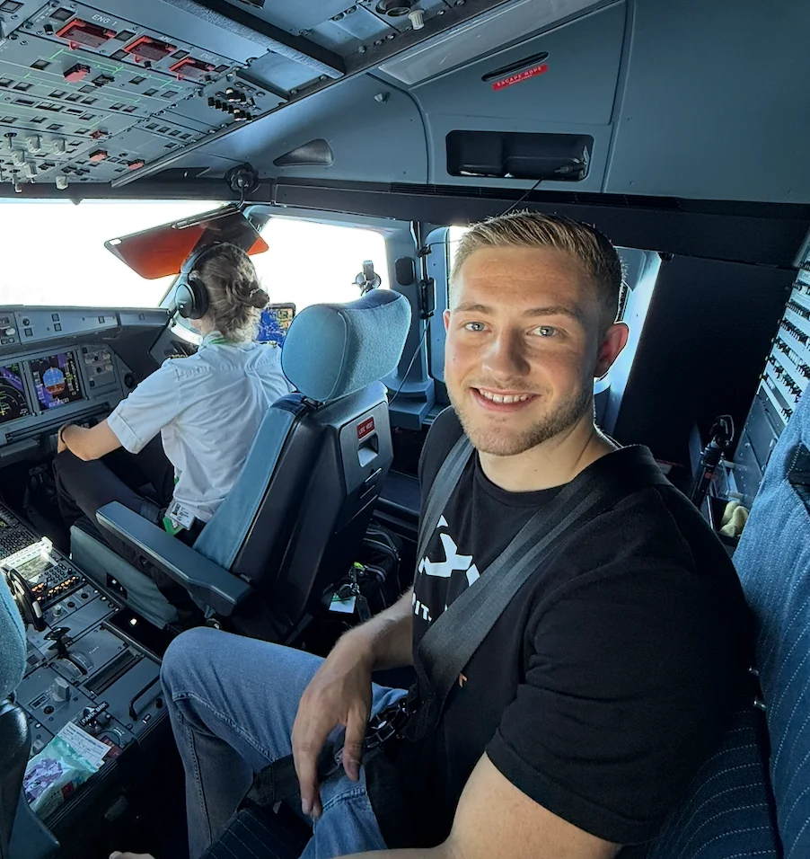 Dan sitting inside an aircraft cockpit